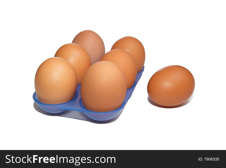 Eggs in the blue container isolated on a white background. Eggs in the blue container isolated on a white background.