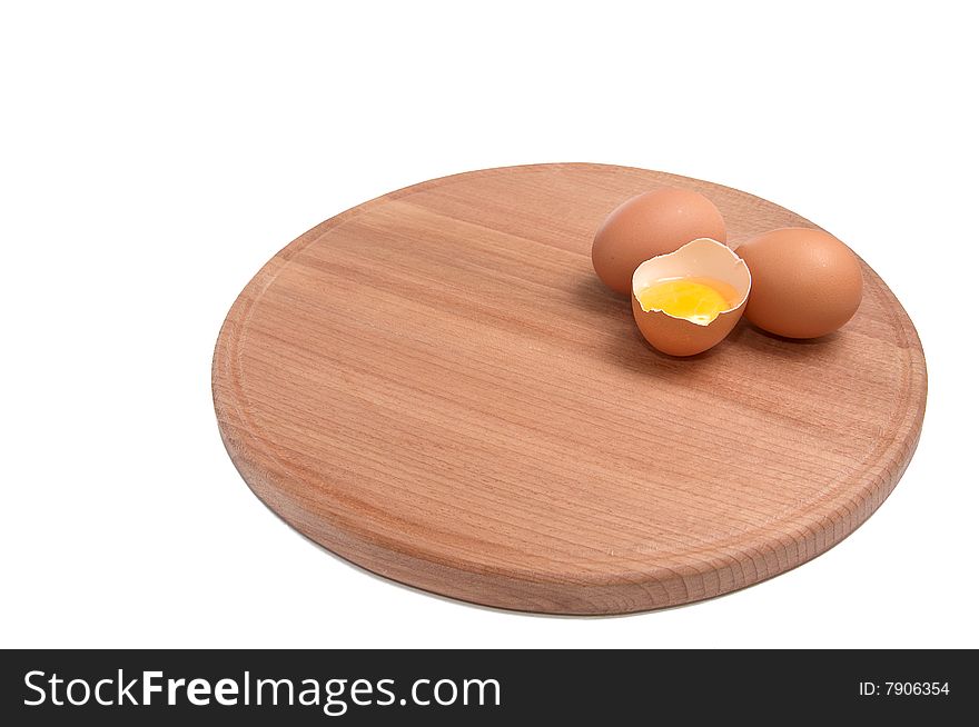 Broken egg on the round board isolated white background. Broken egg on the round board isolated white background.