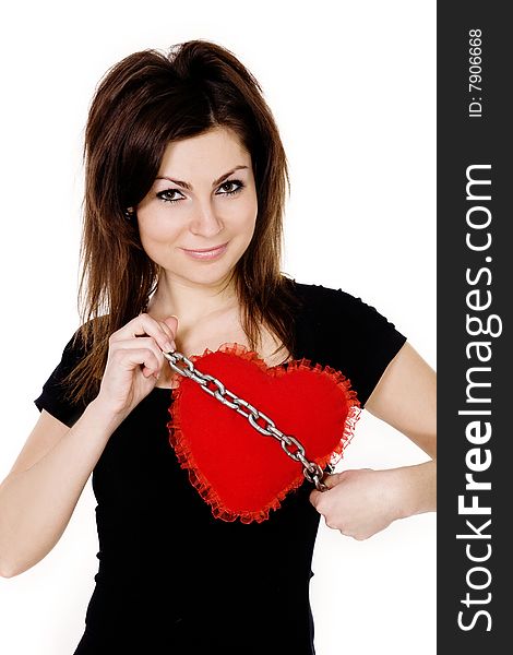 Stock photo: an image of a nice girl with a red heart on a chain. Stock photo: an image of a nice girl with a red heart on a chain