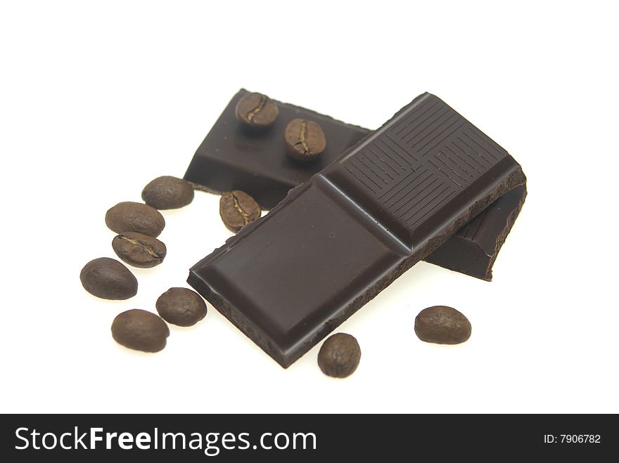 Close up chocolate square and coffee beans isolated