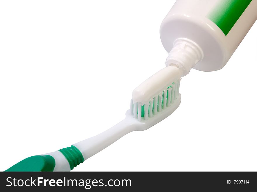Green toothbrush and tube - isolated on white background