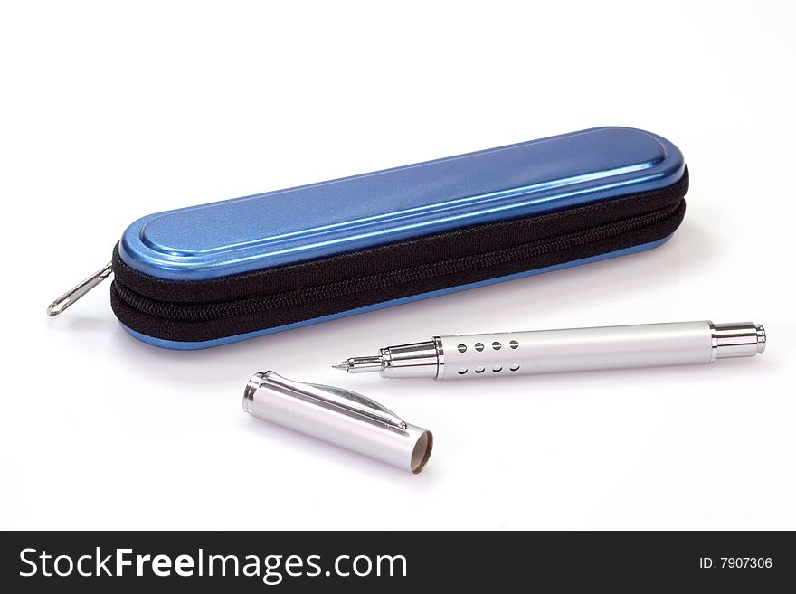 Silver ballpen and a blue pencil case over white background. Silver ballpen and a blue pencil case over white background