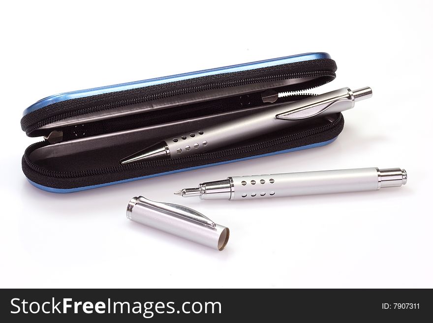 Silver ballpen and rollerball pen in a blue case over white background. Silver ballpen and rollerball pen in a blue case over white background