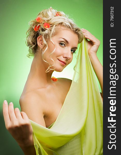 Beautiful young woman with fresh flowers in her hair. Spring concept.