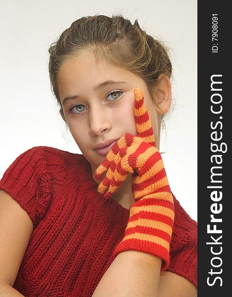 Beautiful young girl posing with gloves against a light background. Beautiful young girl posing with gloves against a light background