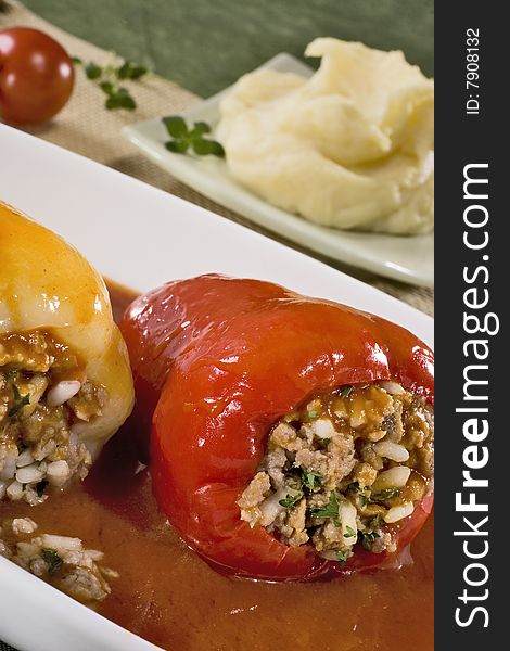 Two stuffed peppers in sauce