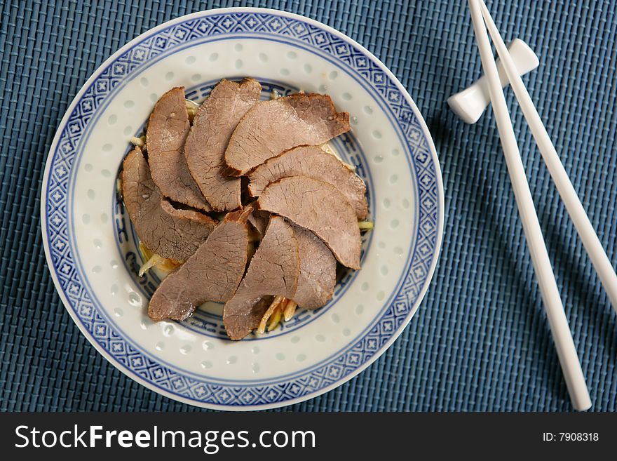 Boiled beef slices with vegetables on plate