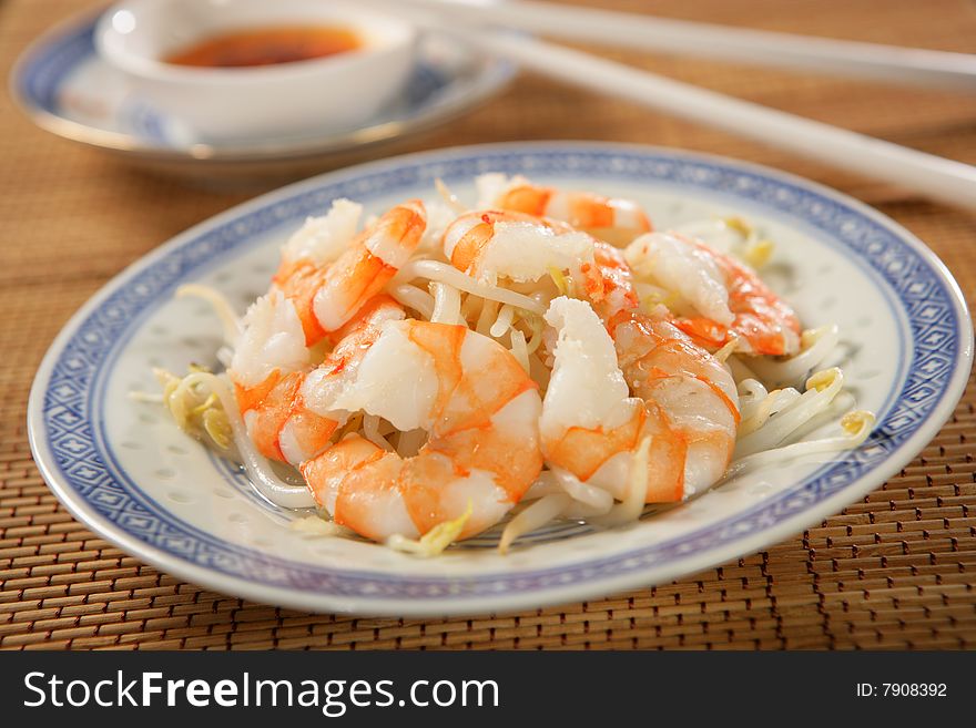 Shrimps with soya sprouts on plate