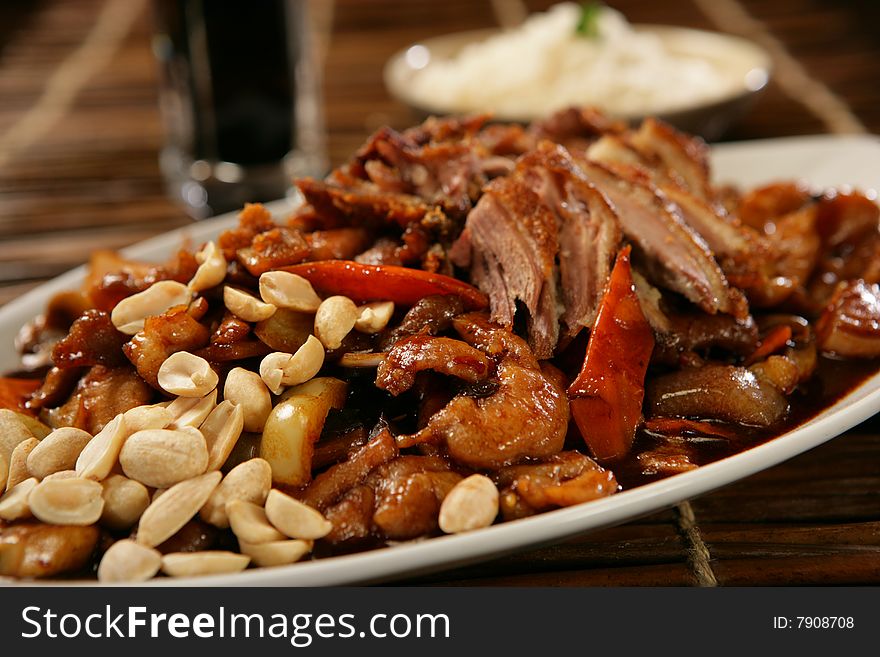 Spicy pork roast with peanuts on plate