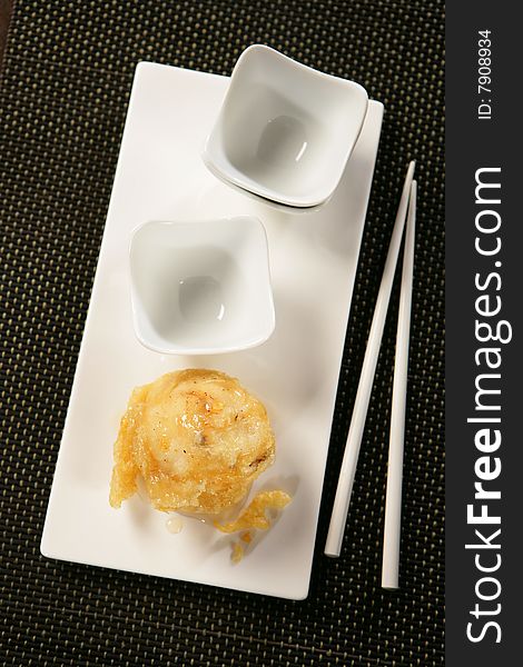 Deep fried pear and chopsticks on plate