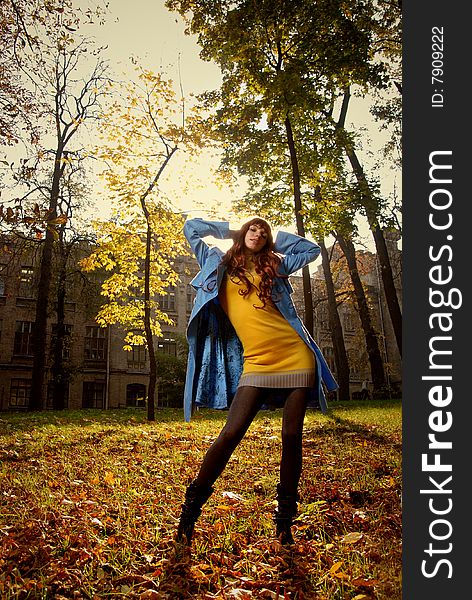 Woman In Blue Jaket Posing In Autumn Park