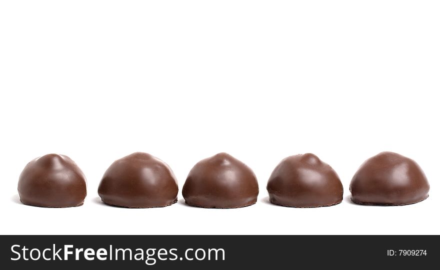 Line of chocolate sweets isolated on white