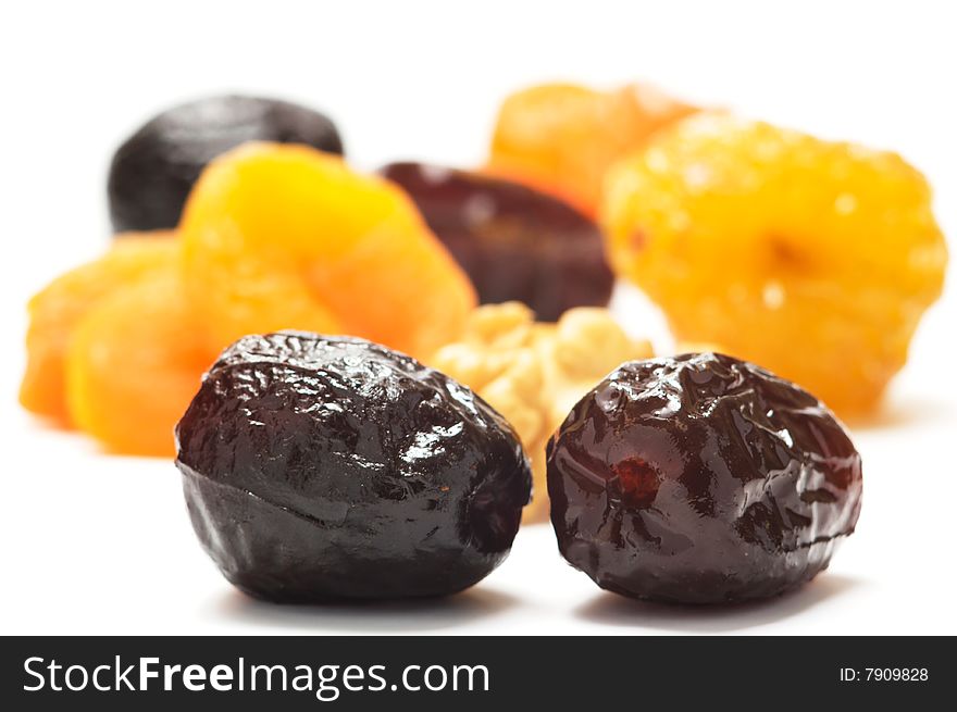 Dates and different dried fruits isolaned on a white background. Background blurry.