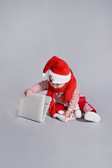 Baby Santa Claus With White Laptop Royalty Free Stock Image Baby Santa Claus With White Laptop Royalty Free Stock Image