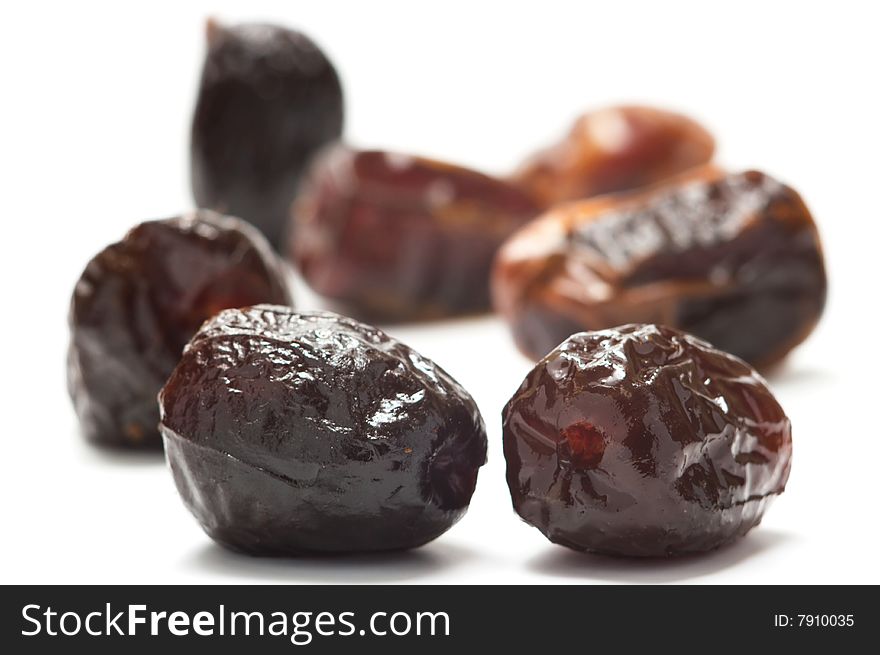 Dried dates isolated on a white background. Background blurry.