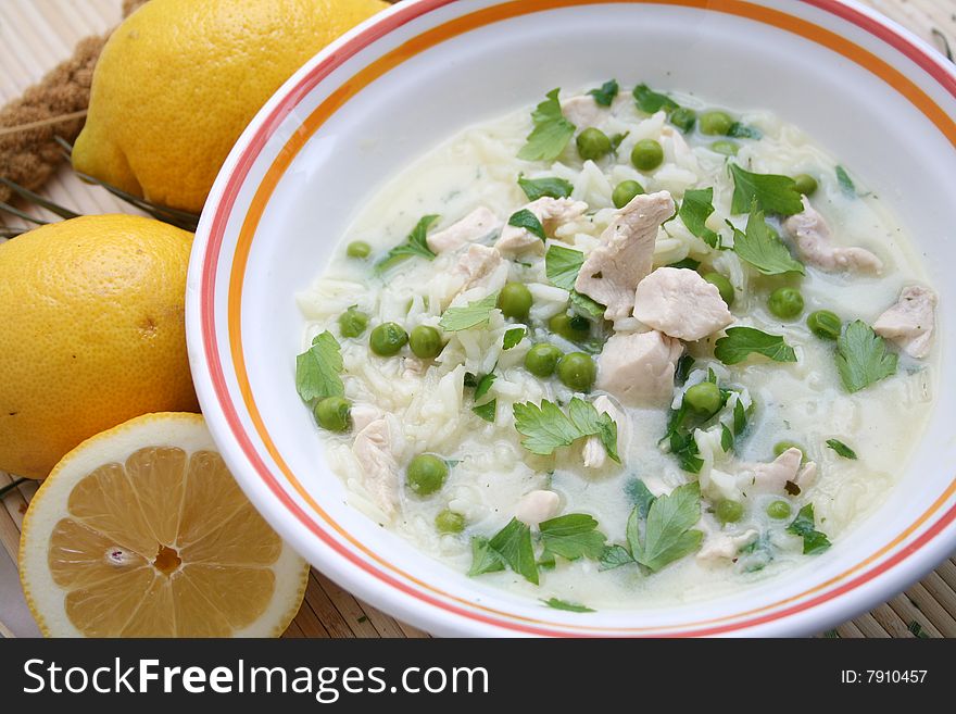 A fresh lemon soup with peas and chicken meat