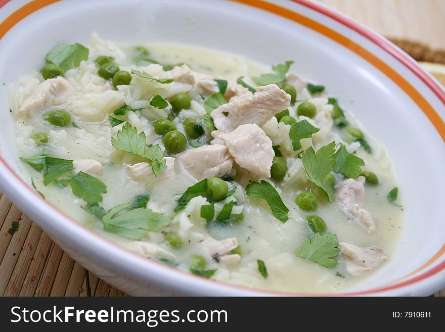 A lemon soup with chicken and peas