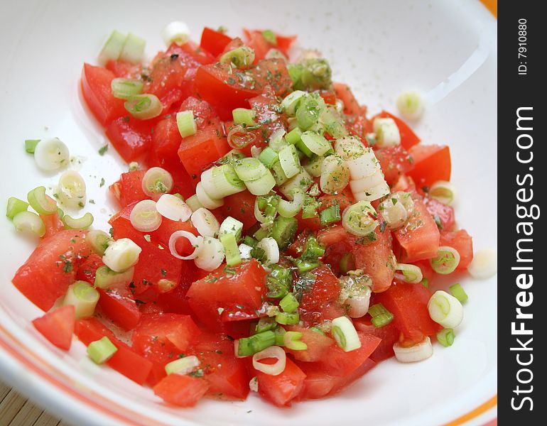 A fresh salad of tomatoes with spring onions