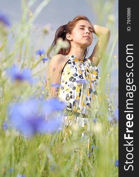 Relaxed young woman in flowers. Relaxed young woman in flowers