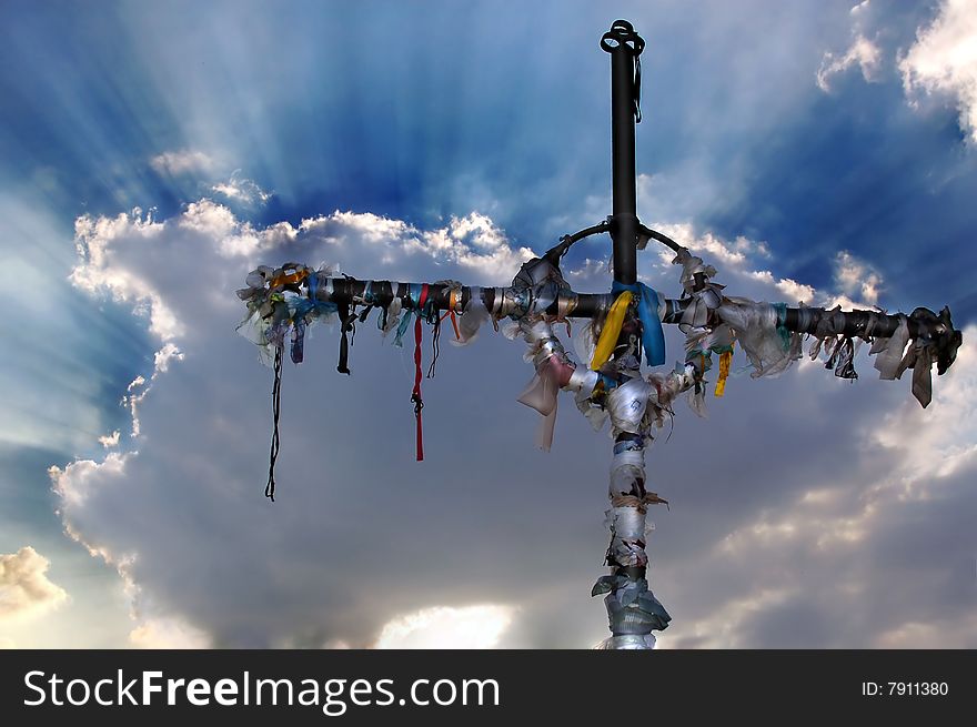 Cross with ribbons against dramatic  clouds. Cross with ribbons against dramatic  clouds