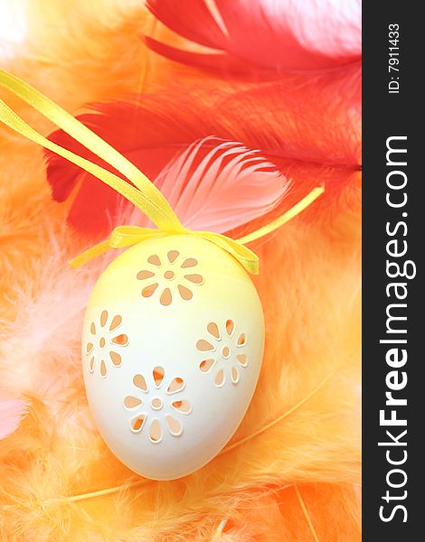 Easter eggs with pink,red and orange feathers.