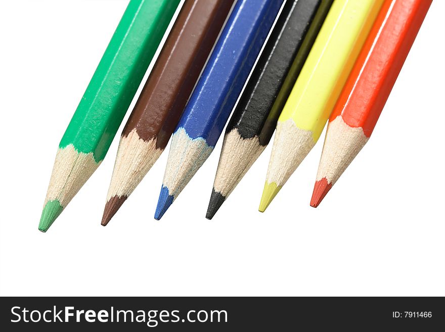 Close-up of various coloured pencils standing on white background