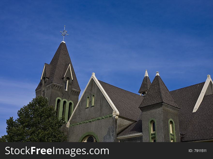 A gray stone church against a deep blue sky. A gray stone church against a deep blue sky