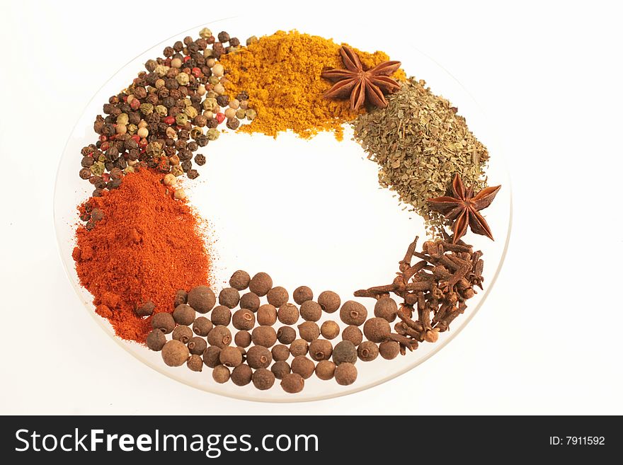 Spices on glass plate isolated ion white