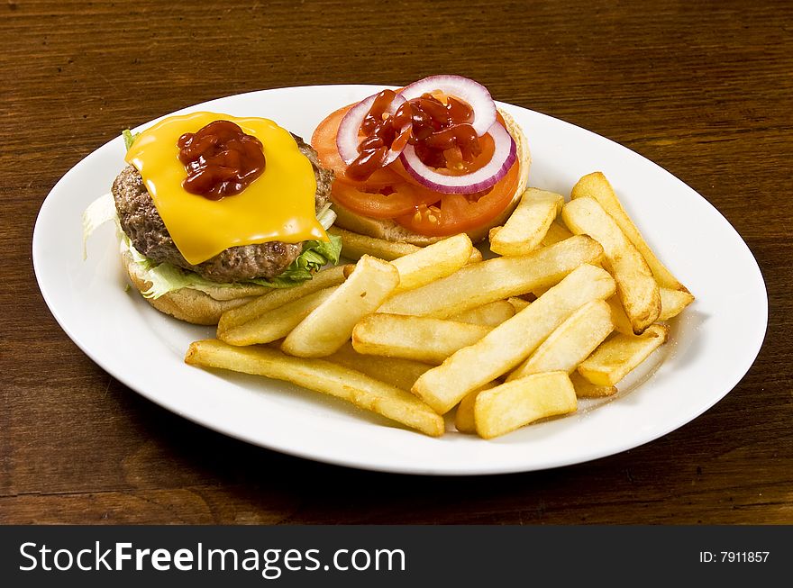 Cheeseburger with ketchup and french fries. Cheeseburger with ketchup and french fries