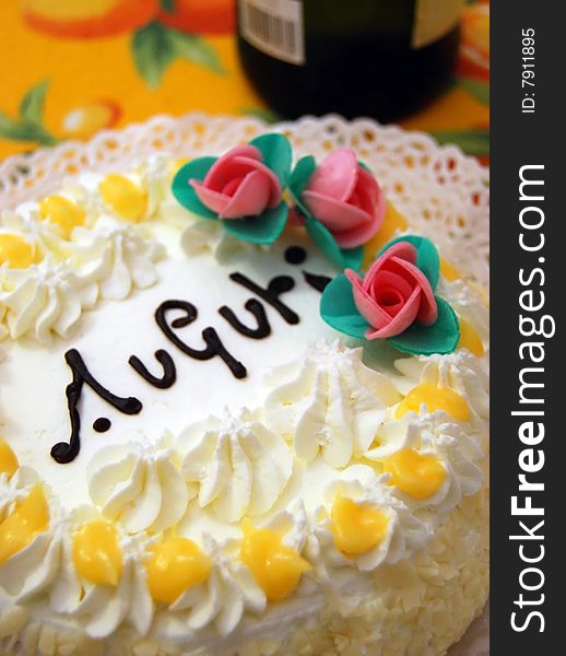 Birthday cake with auguri, cream and little roses