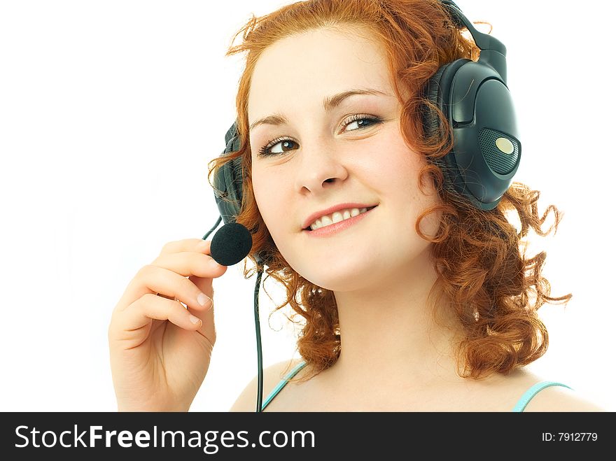 Happy beautiful girl wearing earphones with a microphone, talking to her friend and smiling. Happy beautiful girl wearing earphones with a microphone, talking to her friend and smiling