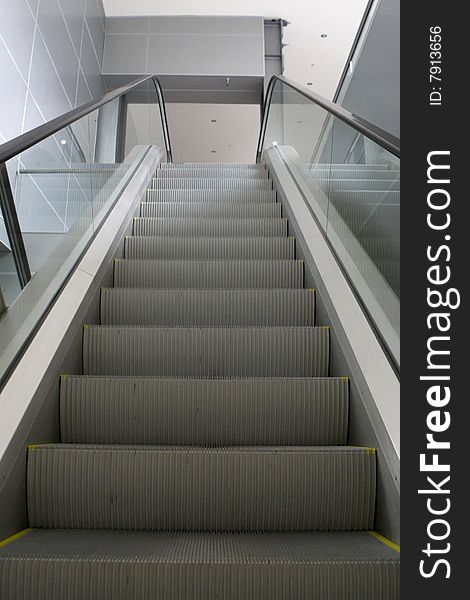 Grey escalator in business center in daylight