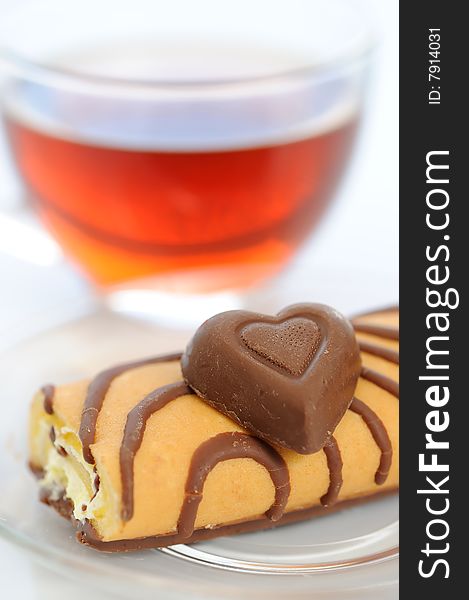 Cake and chocolate heart with cup of tea. Cake and chocolate heart with cup of tea