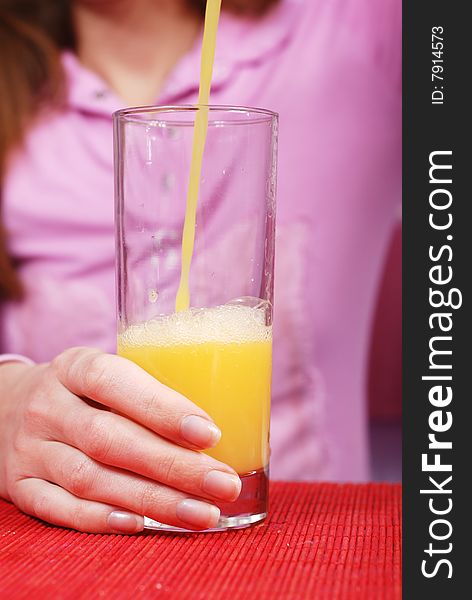 Woman pour a glass of fresh juice. Woman pour a glass of fresh juice