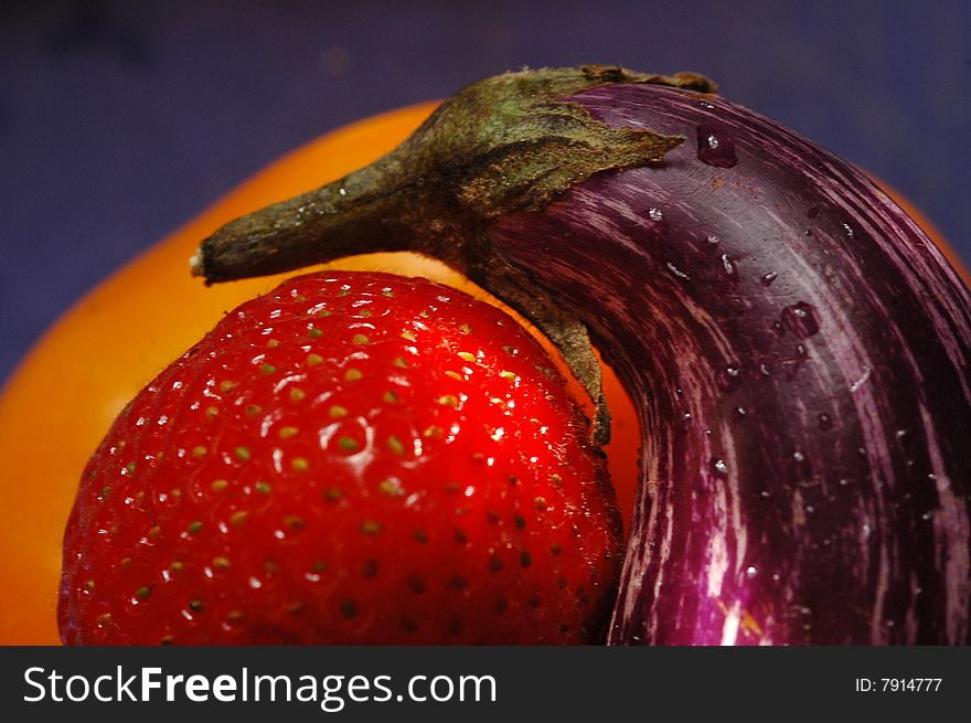 Close-up of strawberry, small eggplant, and yellow pepper. Close-up of strawberry, small eggplant, and yellow pepper