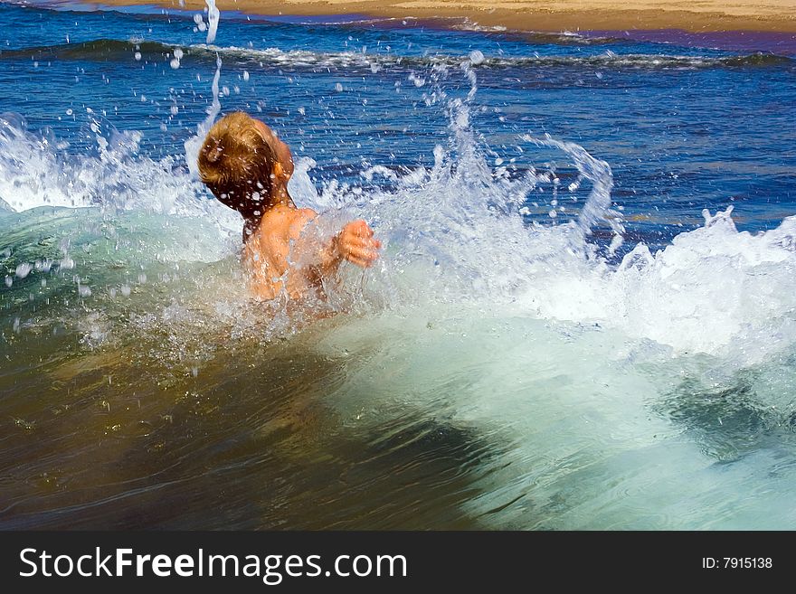 Young child playing in the waves. Young child playing in the waves