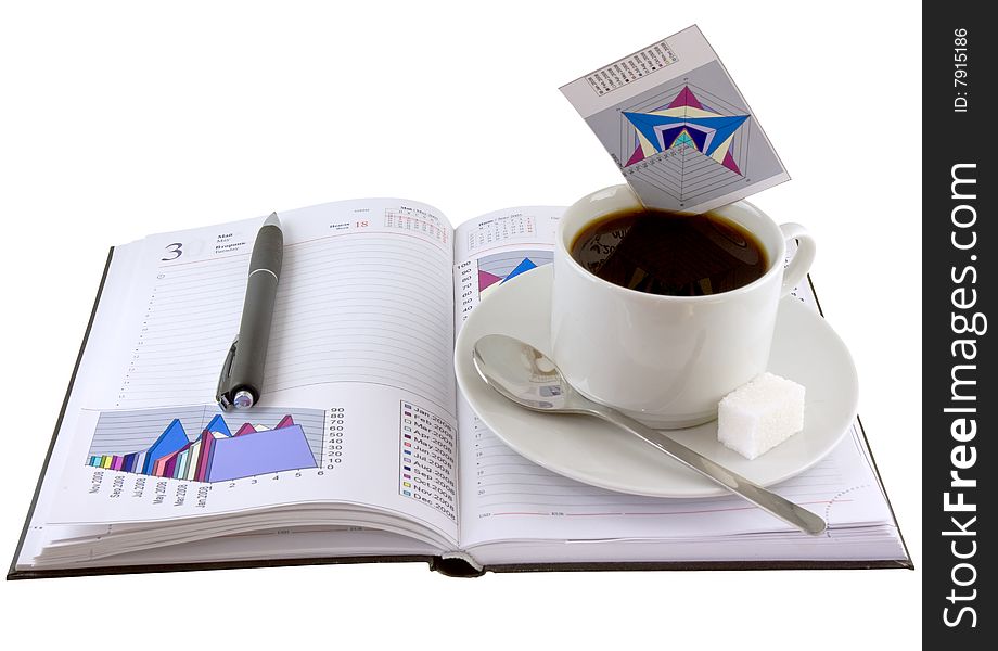 Coffee cup, pen, standing on the open personal organizer and  financial  diagrams  on a pages.Isolated. Coffee cup, pen, standing on the open personal organizer and  financial  diagrams  on a pages.Isolated.