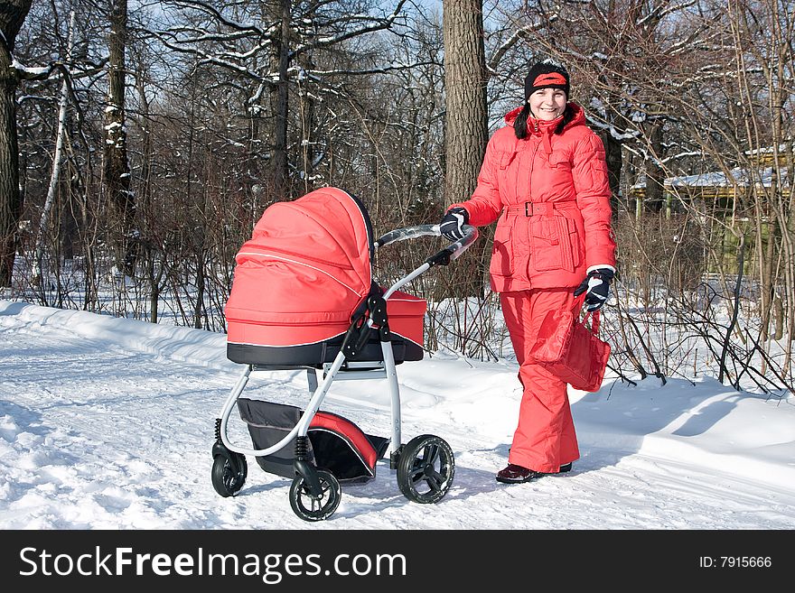 Young woman in red with red baby carriage