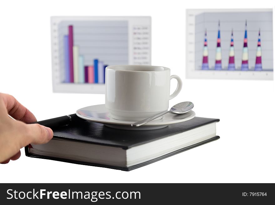 Coffee cup, standing on the black personal organizer, on a back background - two financial  diagrams . Isolated on white. Coffee cup, standing on the black personal organizer, on a back background - two financial  diagrams . Isolated on white.