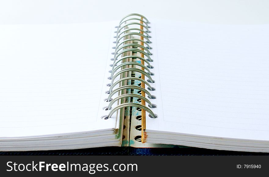 Open notebook with rings on white background