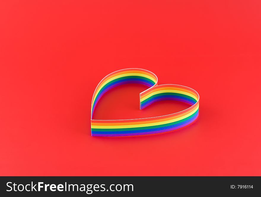 Single  heart, paint  of a six-colour gay flag on red background. Focus on front side. Single  heart, paint  of a six-colour gay flag on red background. Focus on front side.