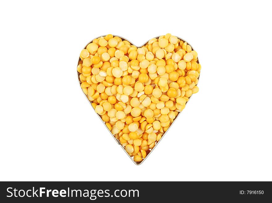 Dried yellow split peas in a heart shaped frame. Dried yellow split peas in a heart shaped frame