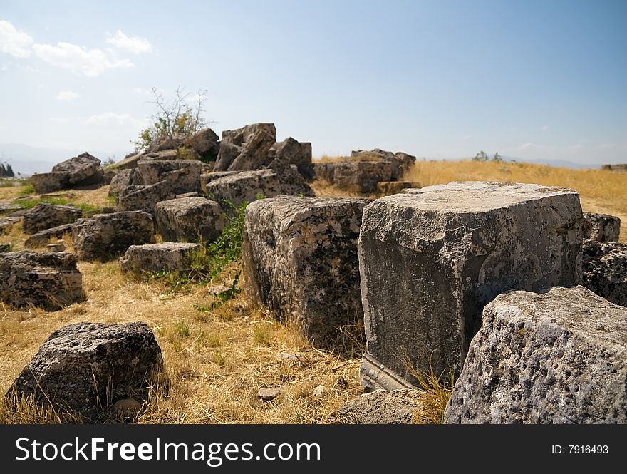 The big square stones which have remained after building of an ancient temple. Pamukkale. Turkey. The big square stones which have remained after building of an ancient temple. Pamukkale. Turkey