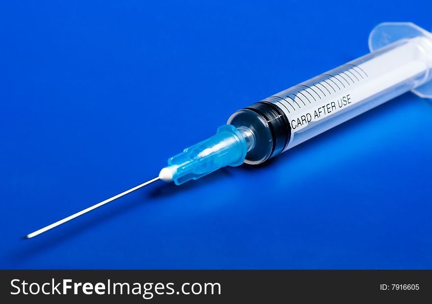 Syringe On Blue