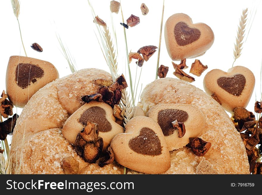 Baked goods with wheat on white background
