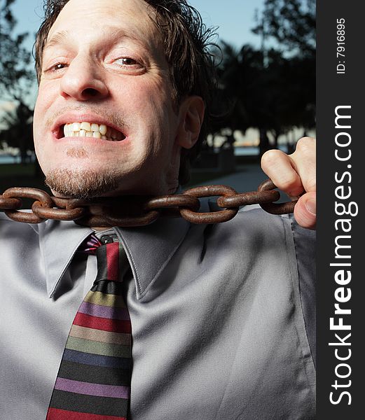 Businessman choking on a chain. Businessman choking on a chain