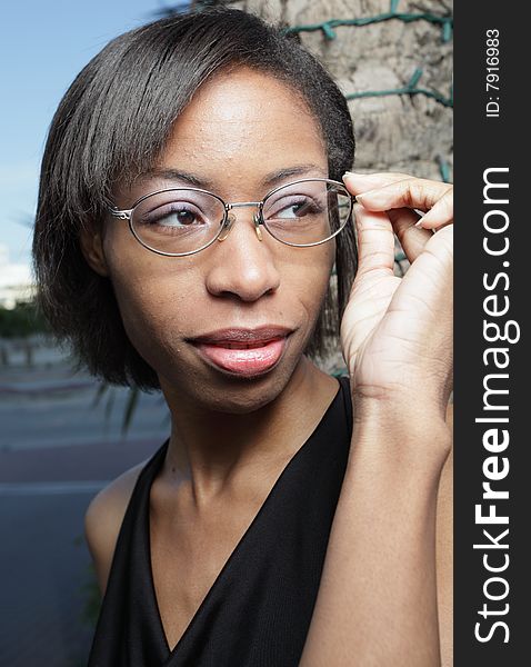 Woman Adjusting Her Reading Glasses