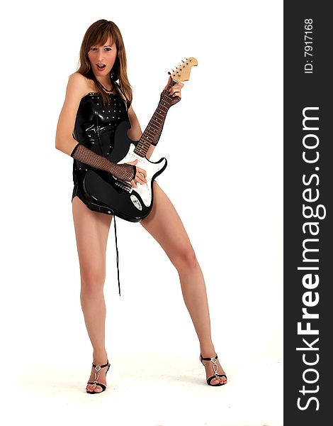 Woman in patent leather playing guitar and singing. Woman in patent leather playing guitar and singing