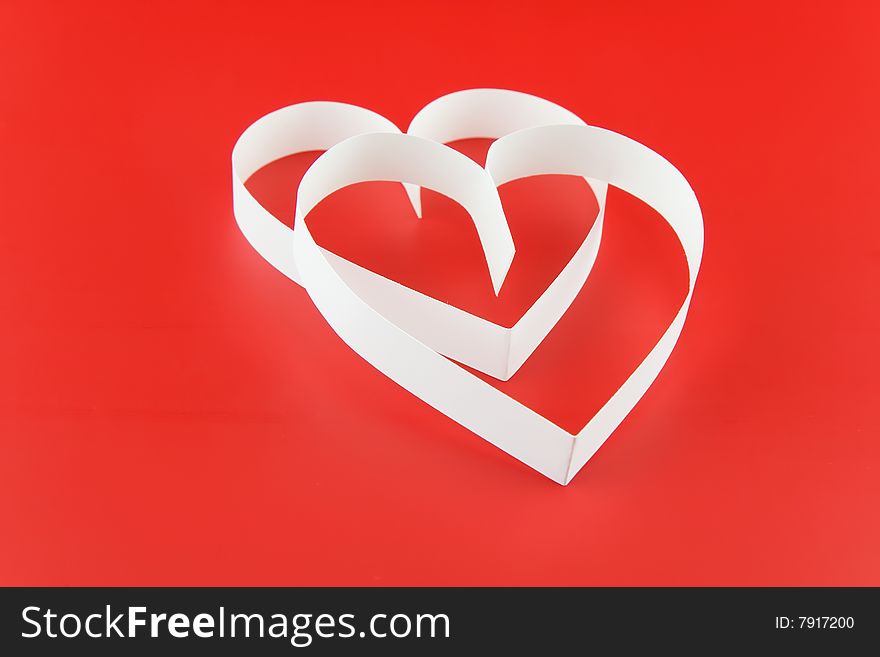 Two white hearts,on red background.
