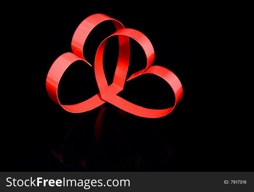 Two hearts with center spot light, on black  background. Two hearts with center spot light, on black  background.